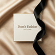 Dom’s Fashion gift card on champagne satin with a black ribbon