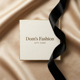 Dom’s Fashion gift card on champagne satin with a black ribbon